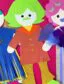 Three vibrant dolls are adorned with paper clothing. Additional details and texture are created with glitter, tape, feathers and pleats.